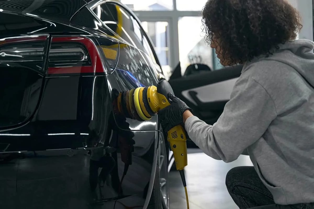 Detailer performing paint correction on a black car in North York