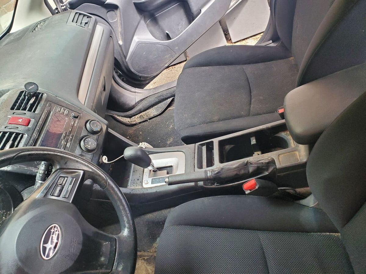 Car interior centre console before detailing, showing dust and grime